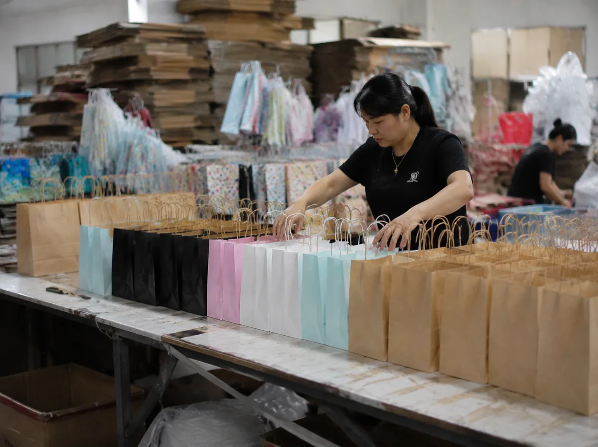 custom printed gift bags and favor bags arranged on an inspection table